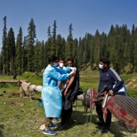A health care worker gives a dose of the Covishield COVID-19 vaccine, made by the Serum Institute of India, to a shepherd in Kashmir\'s Pulwama district on Monday. | REUTERS