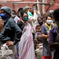People wait to receive their second doses of Covishield in Kolkata, India, last month. | REUTERS