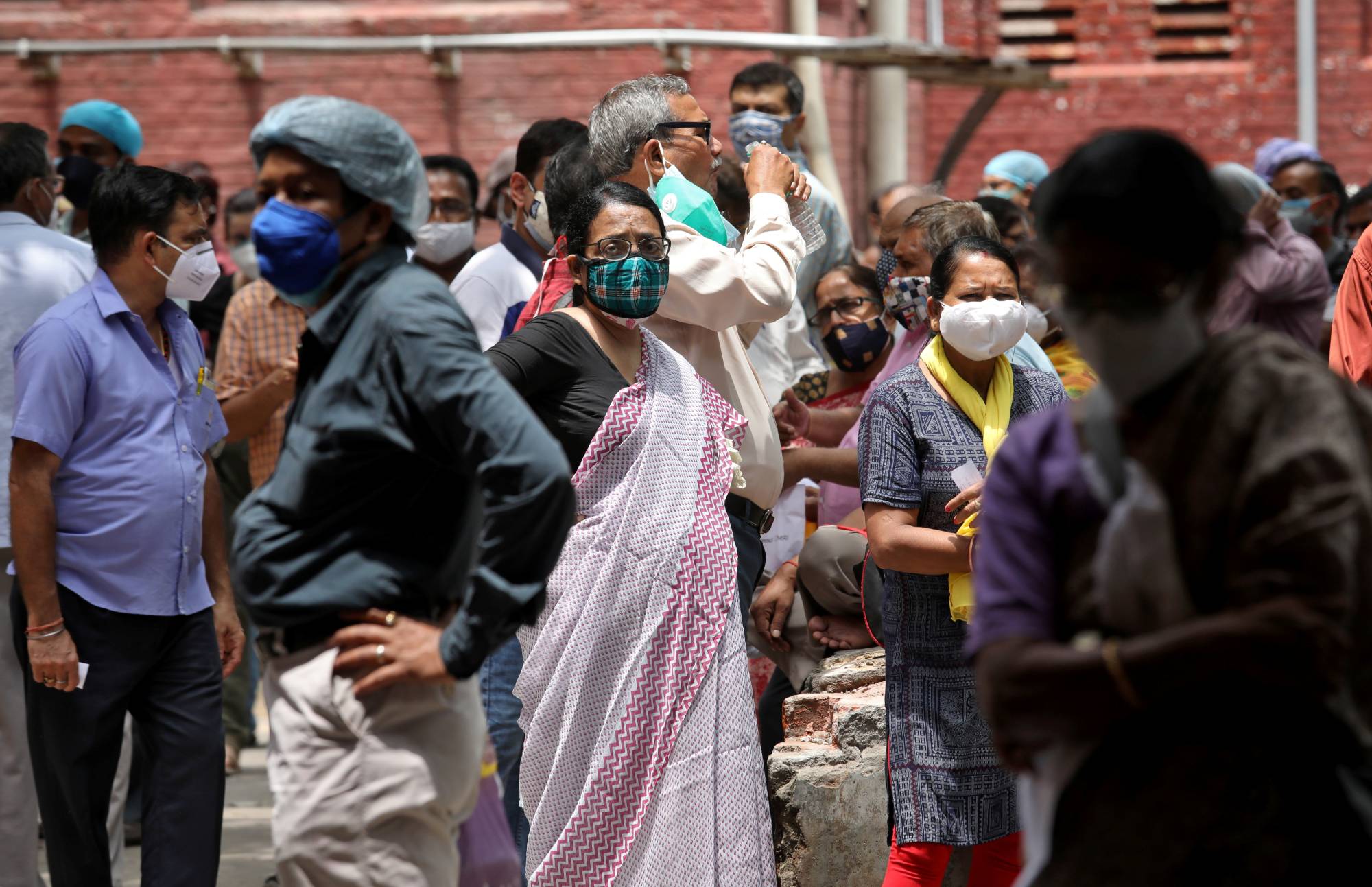 People wait to receive their second doses of Covishield in Kolkata, India, last month. | Reuters