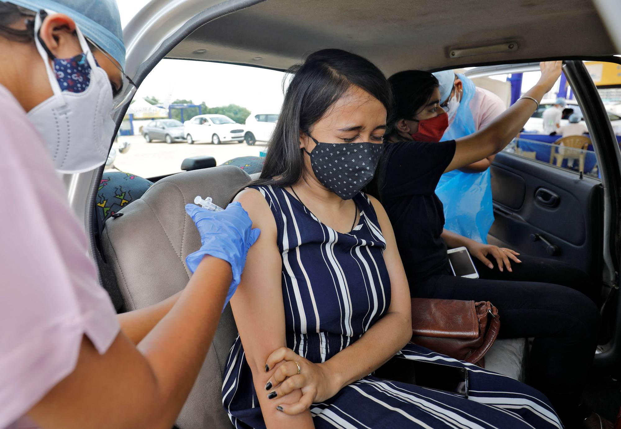 A woman is vaccinated in Ahmedabad, India, in May. The world’s largest vaccine-maker, the Serum Institute of India, was last year named a top supplier of shots to COVAX, the World Health Organization-backed initiative aimed at securing an equitable global rollout. | Reuters