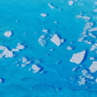 Chunks of ice float inside meltwater pools on top of a glacier near Tasiilaq, Greenland, in 2018.  | REUTERS 