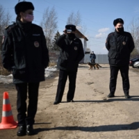 Russian police officers guard the entrance to a penal colony in Pokrov, Russia, in April.  | AFP-JIJI