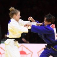 Japanese-born Canadian Christa Deguchi (right) fights against Germany\'s Theresa Stoll in the bronze-medal match of the women\'s 57-kg category during the 2021 Judo World Championships in Budapest on Tuesday. | AFP-JIJI