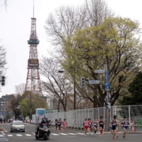 Athletes compete in a half-marathon race which doubles as a test event for the Tokyo Olympics, in Sapporo, on May 5. | POOL / VIA REUTERS
