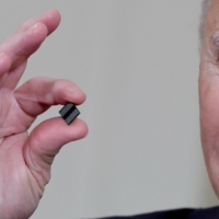 U.S. President Joe Biden holds a semiconductor chip at the White House in February.  | REUTERS 