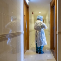 A health worker arrives at a residence to escort a person to Penny\'s Bay Quarantine Center in Hong Kong in March.  | BLOOMBERG 