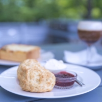 Scones with cream and jam have become a signature menu item at Shozo Kikuchi’s empire of cafes. | SOLVEIG BOERGEN
