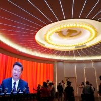 Chinese President Xi Jinping is shown on a screen during an event marking the 100th founding anniversary of the Communist Party of China at the Memorial of the First National Congress of the Communist Party of China in Shanghai on June 4. | REUTERS