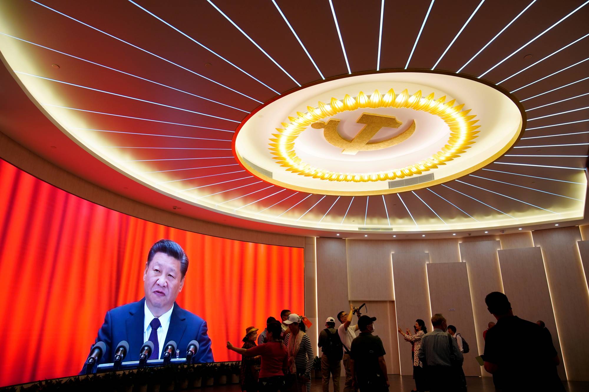 Chinese President Xi Jinping is shown on a screen during an event marking the 100th founding anniversary of the Communist Party of China at the Memorial of the First National Congress of the Communist Party of China in Shanghai on June 4. | REUTERS
