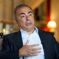 Fugitive former car executive Carlos Ghosn gestures as he talks during an interview in Beirut on Monday. | REUTERS