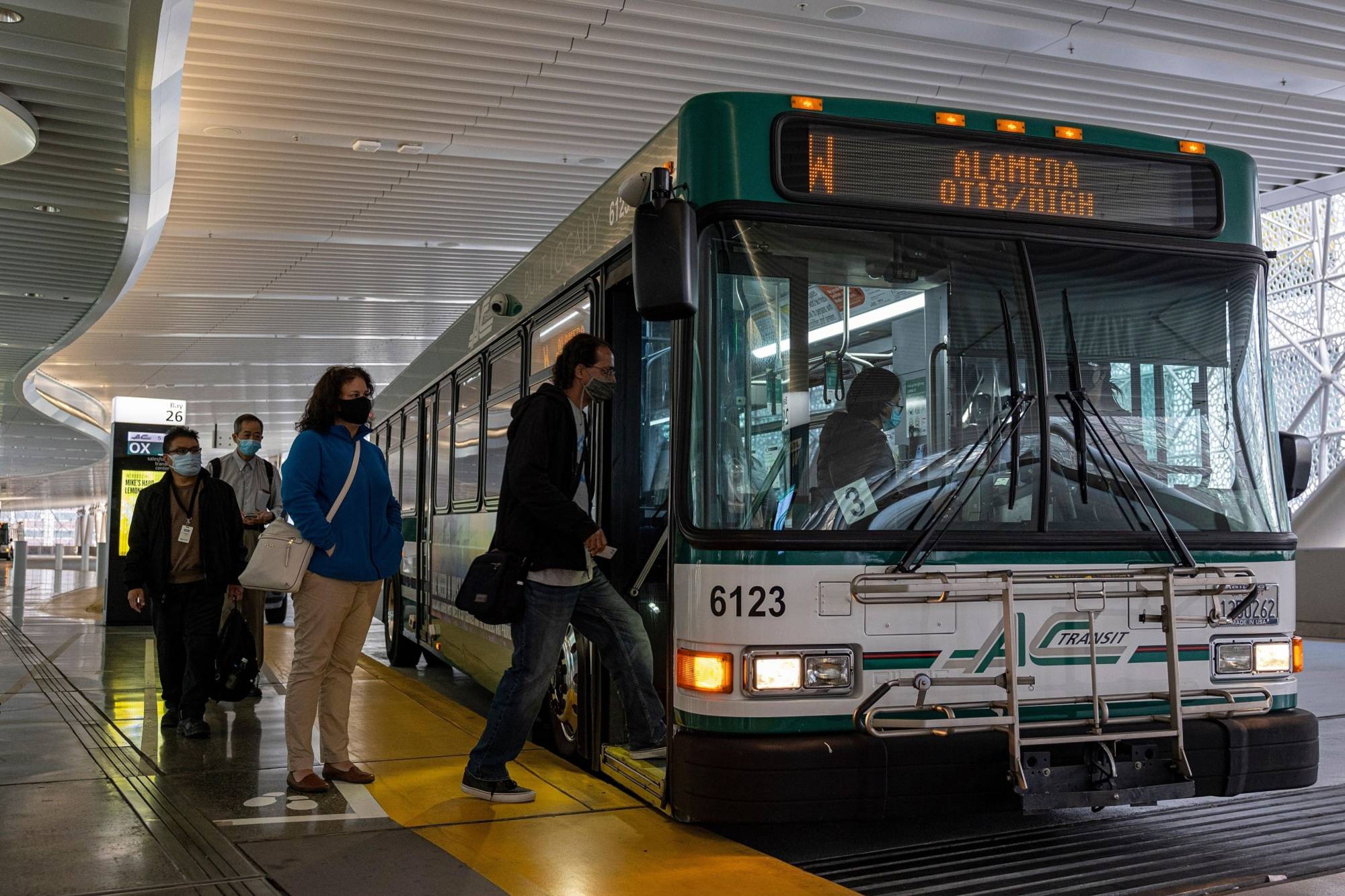 Commuters board a bus at the Salesforce Transit Center in San Francisco on June 9. | Bloomberg 