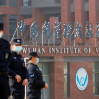 Security personnel keep watch outside Wuhan Institute of Virology during the visit by the World Health Organization team tasked with investigating the origins of COVID-19, in Wuhan, China, on Feb. 3. | REUTERS