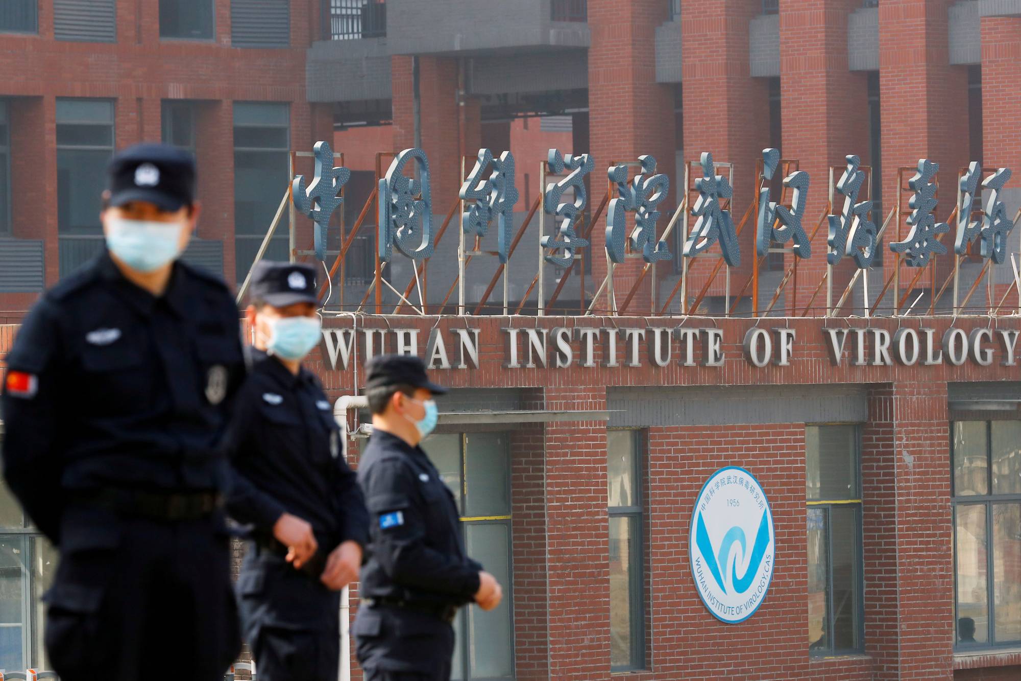 Security personnel keep watch outside Wuhan Institute of Virology during the visit by the World Health Organization team tasked with investigating the origins of COVID-19, in Wuhan, China, on Feb. 3. | REUTERS