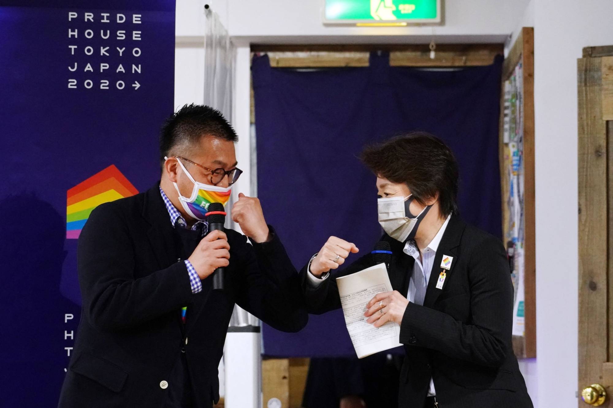 Tokyo 2020 chief Seiko Hashimoto (right) and Gon Matsunaka, head of Pride House Tokyo Legacy, greet each another at Pride House Tokyo Legacy in Tokyo on April 27. | GETTY IMAGES / VIA BLOOMBERG