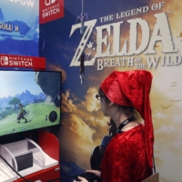 A gamer plays The Legend of Zelda : Breath of the Wild, developed and published by Nintendo, on a Nintendo Switch games console during the Paris Games Week in October 2017 in Paris. | BLOOMBERG