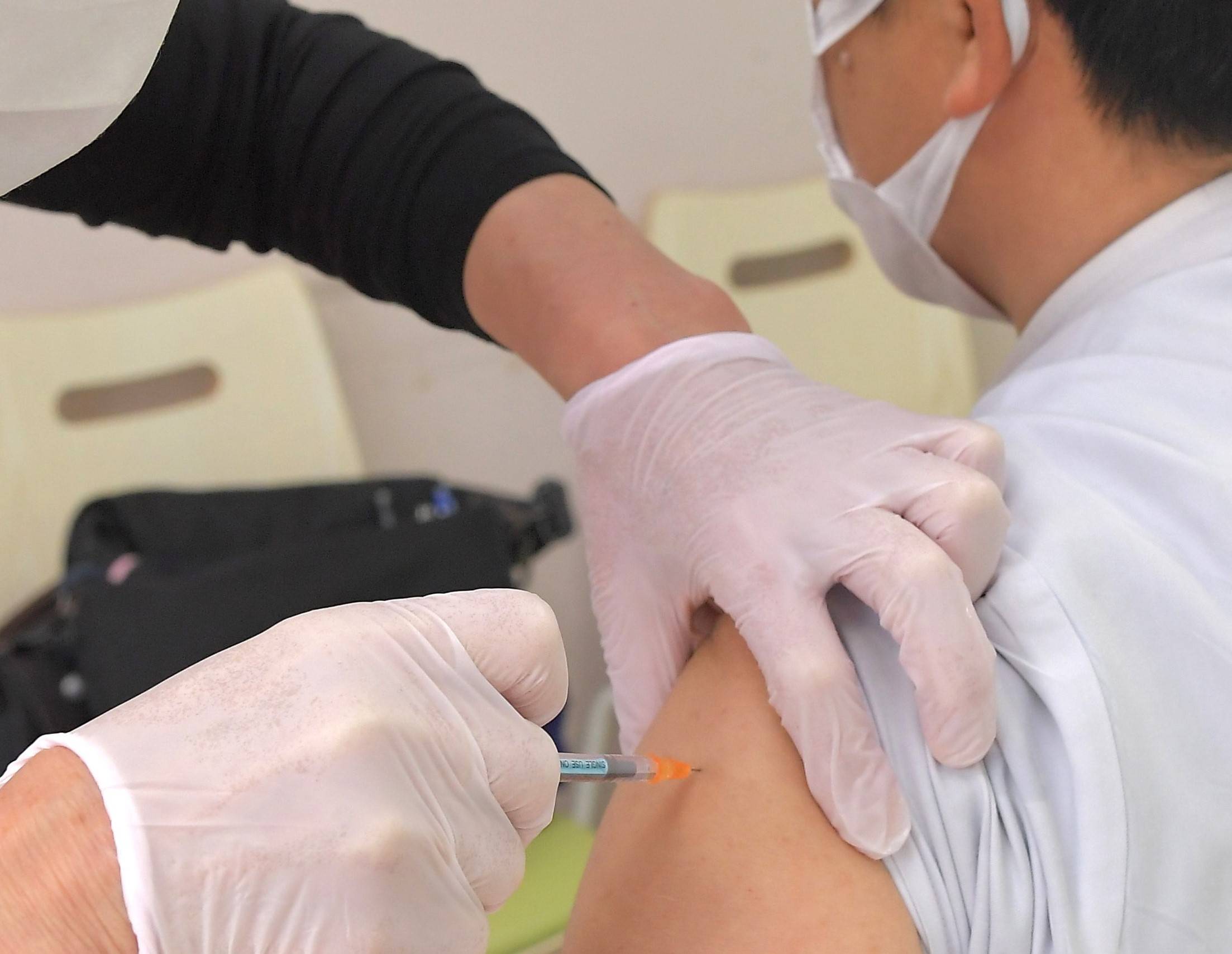 Medical workers have been discouraged from helping with COVID-19 inoculations due to what is called the '¥1.3 million income hurdle.' | KAHOKU SHIMPO