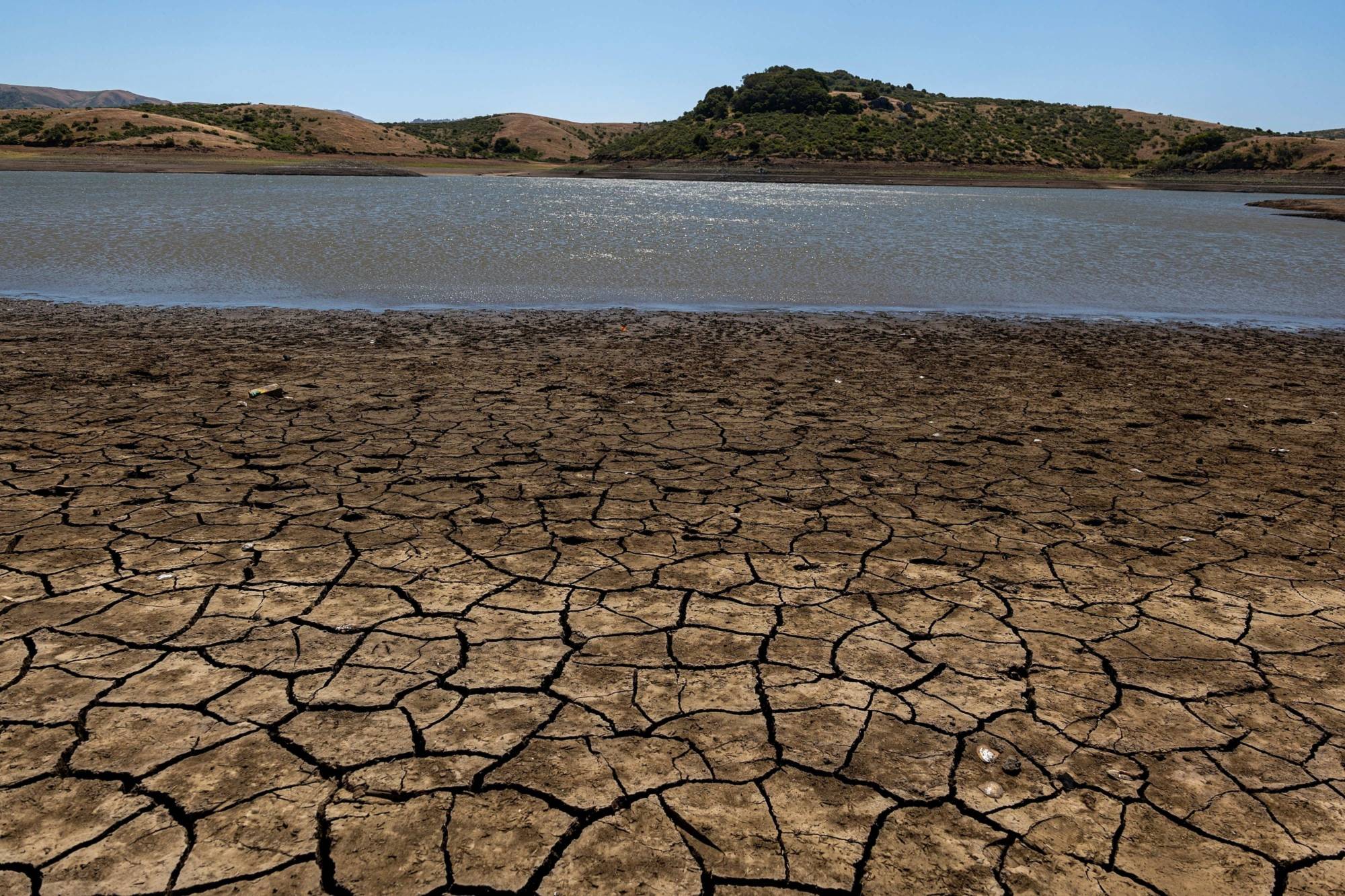 A cracked lake bed at Nicasio Reservoir during a drought in Nicasio, California, on May 27 | BLOOMBERG 
