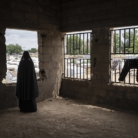 A woman who was kidnapped by Boko Haram and was recruited as a bomber stands for a portrait in August 2019, at Konduga IDP camp in Nigeria. | LAURA BOUSHNAK / THE NEW YORK TIMES