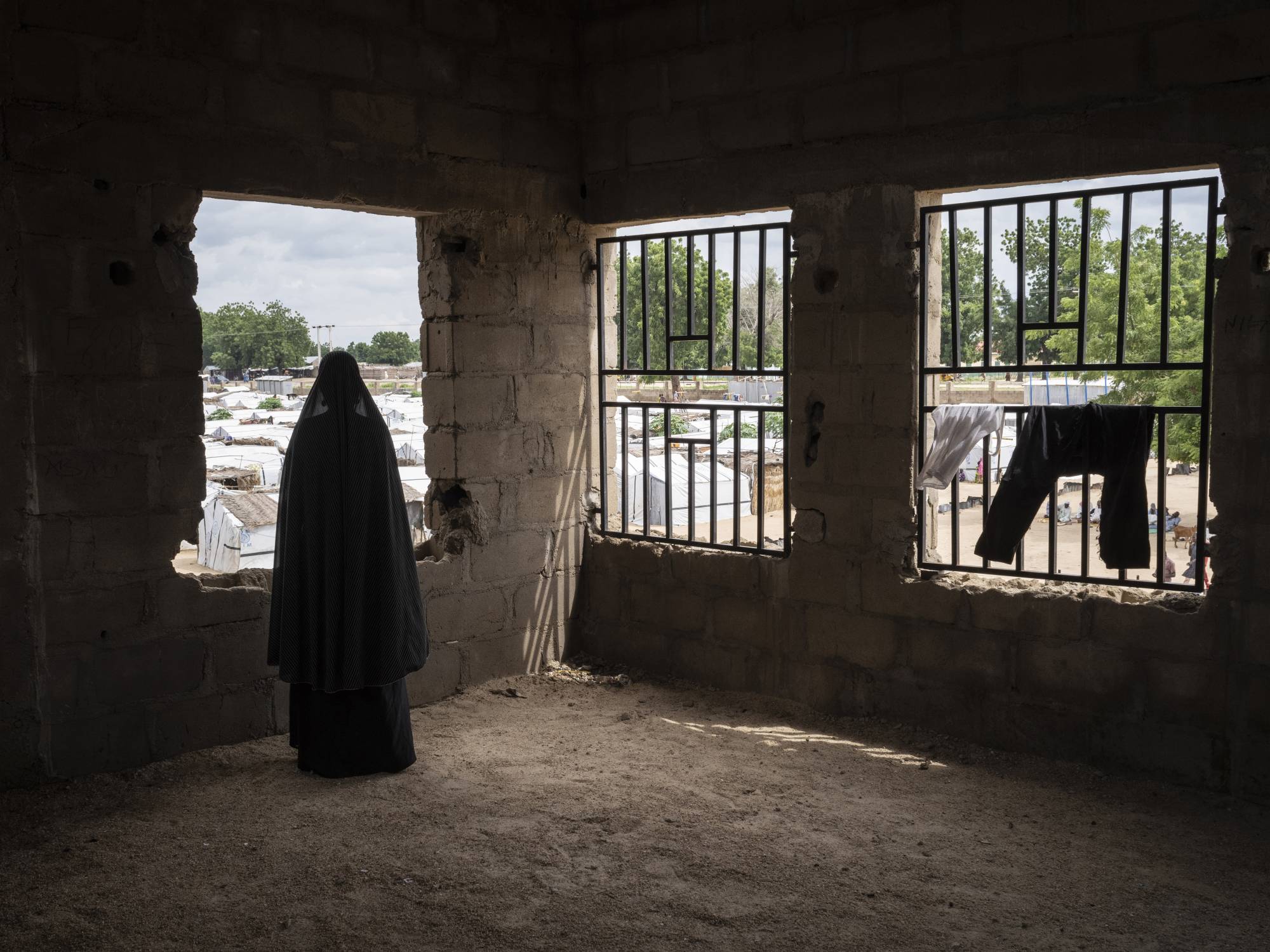 A woman who was kidnapped by Boko Haram and was recruited as a bomber stands for a portrait in August 2019, at Konduga IDP camp in Nigeria. | Laura Boushnak / The New York Times