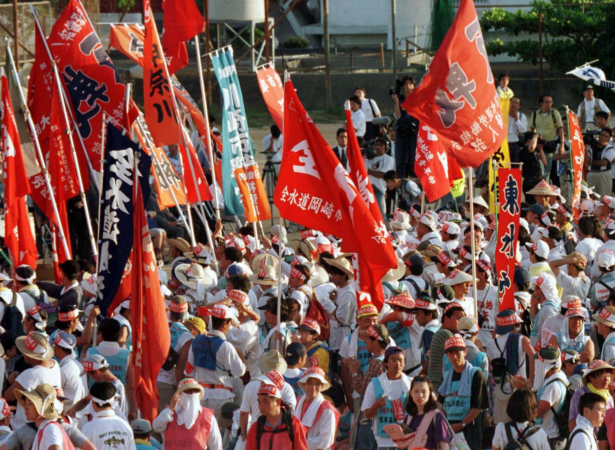 Anti-base demonstrators gather near the U.S. Futenma Air Base in Okinawa on May 15, 1997, to protest against the U.S. military presence on the 25th anniversary of Okinawa's 1972 reversion to Japanese rule.  | REUTERS