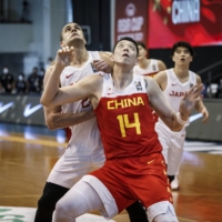 China\'s Shen Zijie and Japan\'s Gavin Edwards compete for a rebound during their FIBA Asia Cup qualifying game in Pampanga, Philippines | COURTESY OF FIBA ASIA CUP
