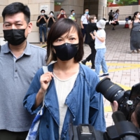 Apple Daily deputy chief editor Chan Pui-man speaks to the media as she leaves court in Hong Kong on Saturday.  | AFP-JIJI