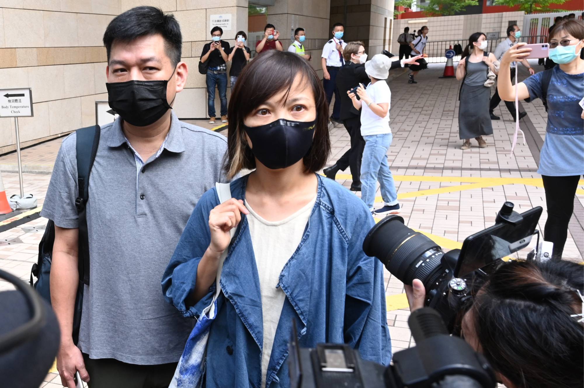 Apple Daily deputy chief editor Chan Pui-man speaks to the media as she leaves court in Hong Kong on Saturday. | AFP-JIJI