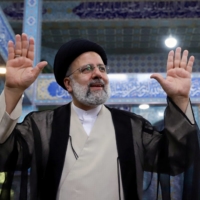 Ebrahim Raisi gestures after casting his vote during presidential elections at a polling station in Tehran on Friday.  | WEST ASIA NEWS AGENCY / VIA REUTERS