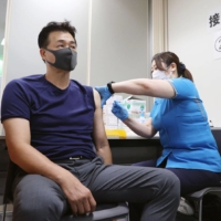 Dragons manager Tsuyoshi Yoda receives a vaccine dose in Tokyo on Monday. | KYODO