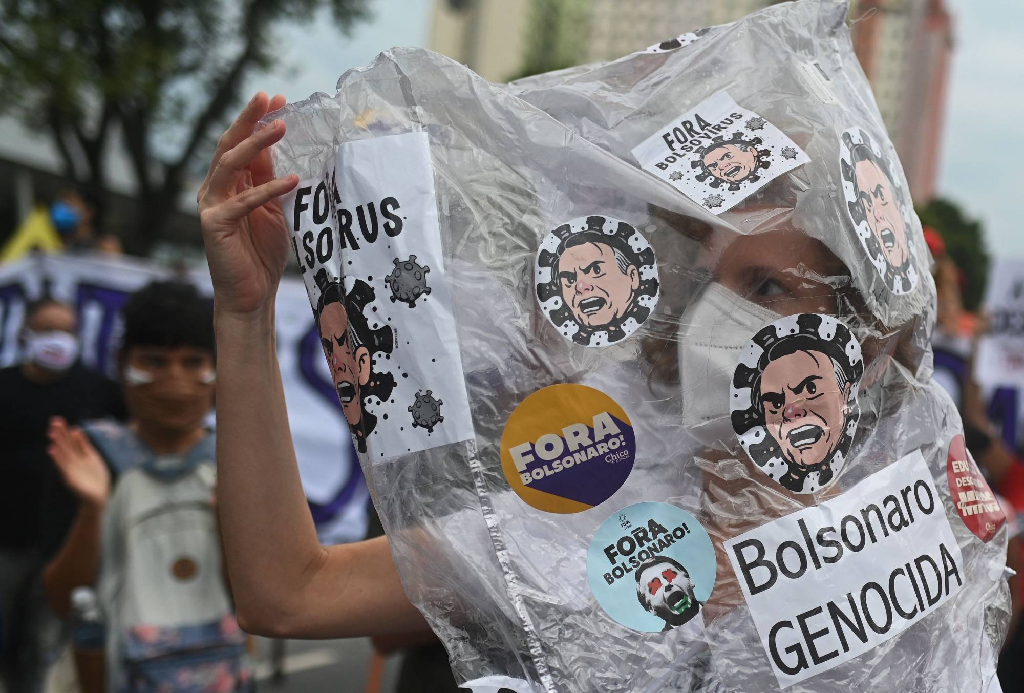 A demonstrator takes part in a protest against Brazilian President Jair Bolsonaro's handling of the COVID-19 pandemic, in Rio de Janeiro on Saturday. Brazil is also facing an election battle next year, with a resurgent left looking to unseat right-wing Bolsonaro. | AFP-JIJI