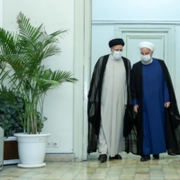 Iran\'s outgoing president, Hassan Rouhani, meets with President-elect Ebrahim Raisi in Tehran on Saturday.  | IRANIAN PRESIDENTIAL WEBSITE / VIA REUTERS