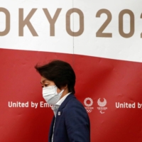 Tokyo Olympics Organising Committee President Seiko Hashimoto arrives at a news conference in Tokyo on Wednesday. | POOL / VIA REUTERS