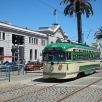 A trolley along the Embarcadero in downtown San Francisco on June 15. The challenges of climate change are everywhere but maybe no more so than in coastal cities that face dual threats of seismic activity and rising seas. | JIM WILSON / THE NEW YORK TIMES