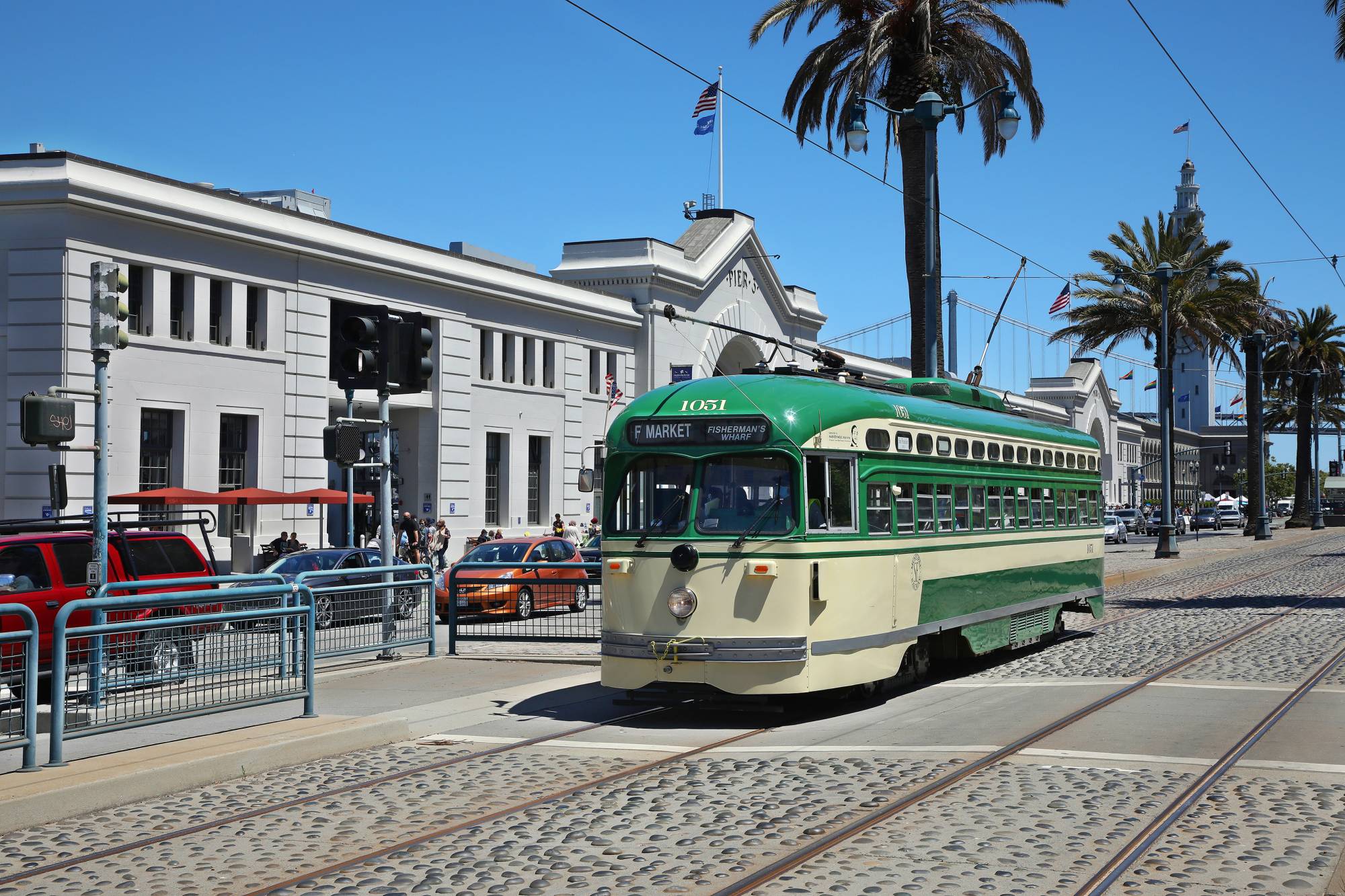 A trolley along the Embarcadero in downtown San Francisco on June 15. The challenges of climate change are everywhere but maybe no more so than in coastal cities that face dual threats of seismic activity and rising seas. | Jim Wilson / The New York Times