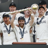 New Zealand captain Kane Williamson celebrates with his team after becoming the world test champions on Wednesday. | REUTERS