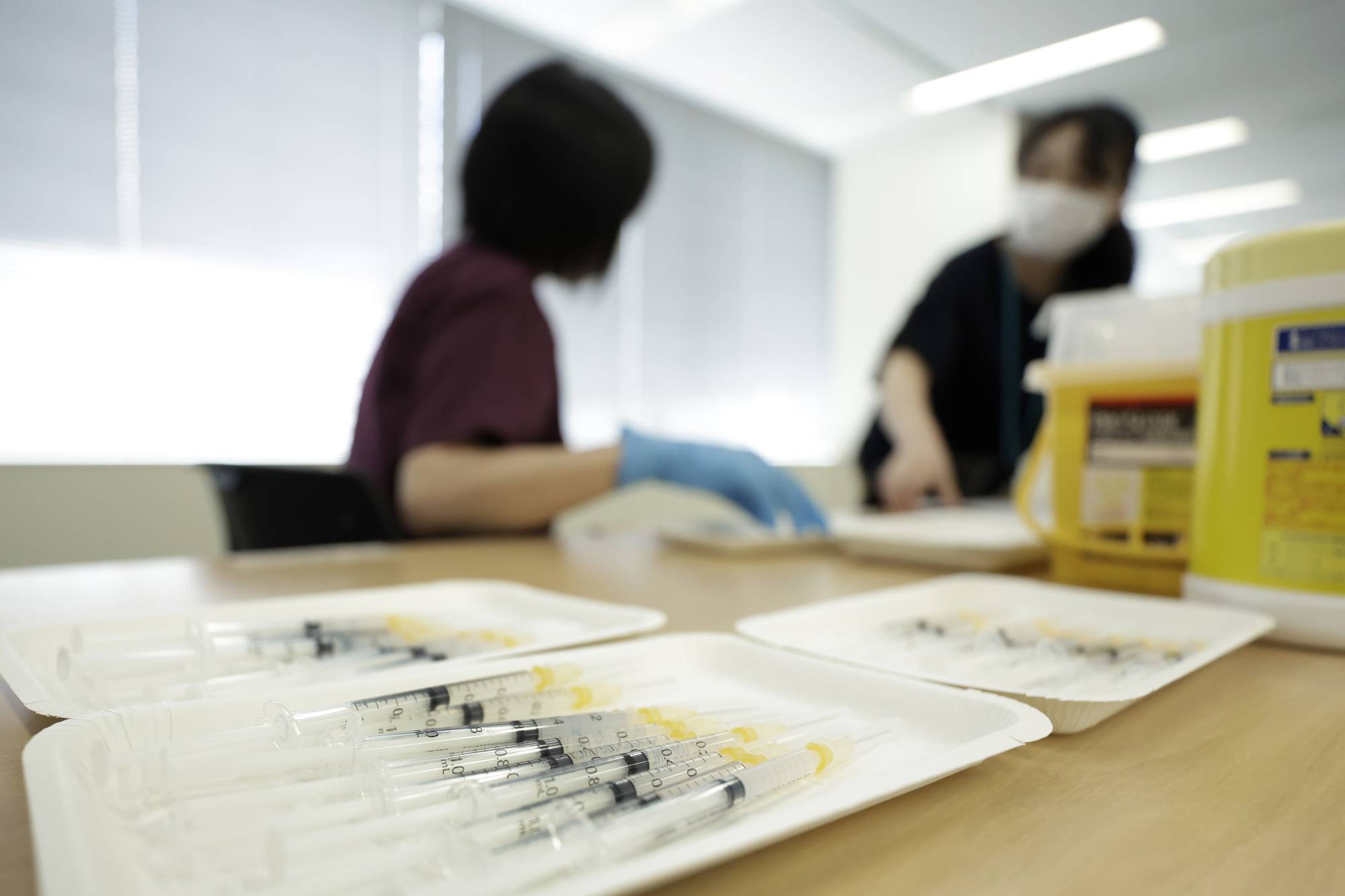 Syringes filled with doses of the Moderna Inc. shot in Tokyo. New infections among front-line health care workers are likely to fall further, as about 75% of them in Tokyo have completed a two-dose vaccine regimen. | BLOOMBERG