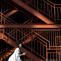 A woman walks next to a stairway entrance to Tokyo Tower. Tokyo confirmed 534 new cases of COVID-19 on Saturday, a significant increase from the 388 reported a week before.  | AFP-JIJI