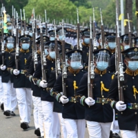Philippine military honor guards march as they escort the carriage carrying the urn of the late President Benigno Aquino at a memorial in Manila on Saturday.  | AFP-JIJI