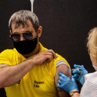 A man receives a dose of Russia\'s Sputnik V vaccine at a center in Moscow on Friday.  | AFP-JIJI