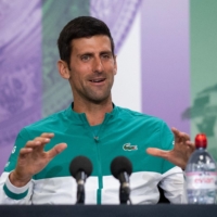 Novak Djkokovic speaks to reporters on Saturday ahead of the start of the Wimbledon Championships in London. | AFP-JIJI