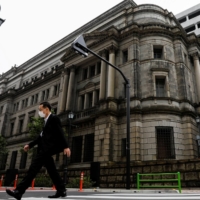 Bank of Japan policymakers hope the accelerating pace of COVID-19 vaccinations will prop up the economy, according to a summary of their June meeting. | REUTERS