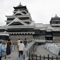Visitors head for the main tower of Kumamoto Castle, which reopened to the public Monday after undergoing repairs following massive earthquakes in 2016. | KYODO