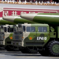Chinese military vehicles carrying DF-26 ballistic missiles travel past Tiananmen Gate during a military parade to commemorate the 70th anniversary of the end of World War II in Beijing in September 2015.  | POOL / VIA REUTERS