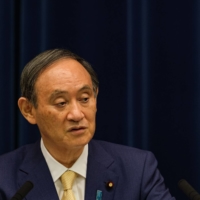 Prime Minister Yoshihide Suga speaks during a news conference in Tokyo on July 8. | BLOOMBERG
