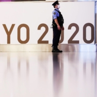 A police officer stands guard at Haneda Airport in Tokyo on July 8. | REUTERS