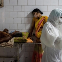 A woman leans against a stretcher carrying her husband at Jawahar Lal Nehru Medical College and Hospital in Bhagalpur, India, in July 2020. | REUTERS 