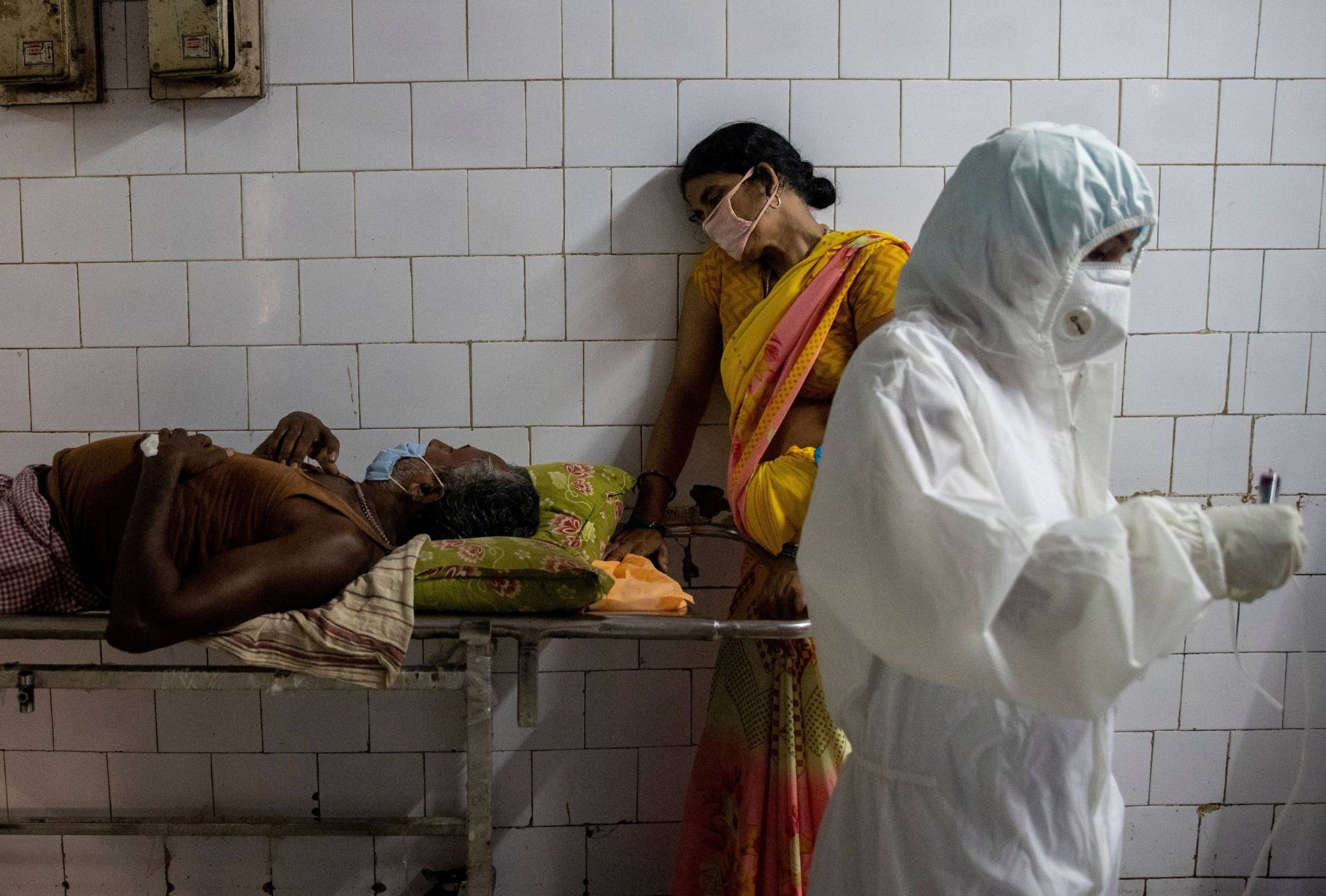 A woman leans against a stretcher carrying her husband at Jawahar Lal Nehru Medical College and Hospital in Bhagalpur, India, in July 2020. | Reuters 