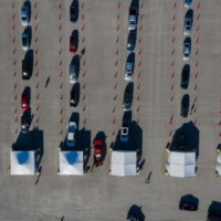 Motorists line up at a mass vaccination site inside the Darlington Raceway in South Carolina in March.  | BLOOMBERG 