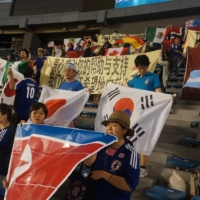 Japanese fans hold banners thanking foreign counties for their support after the March 11 disaster after the final of the U-20 Women\'s World Cup on Sept. 8, 2012, at Tokyo\'s National Stadium. | COURTESY OF HIROKAZU TSUNODA