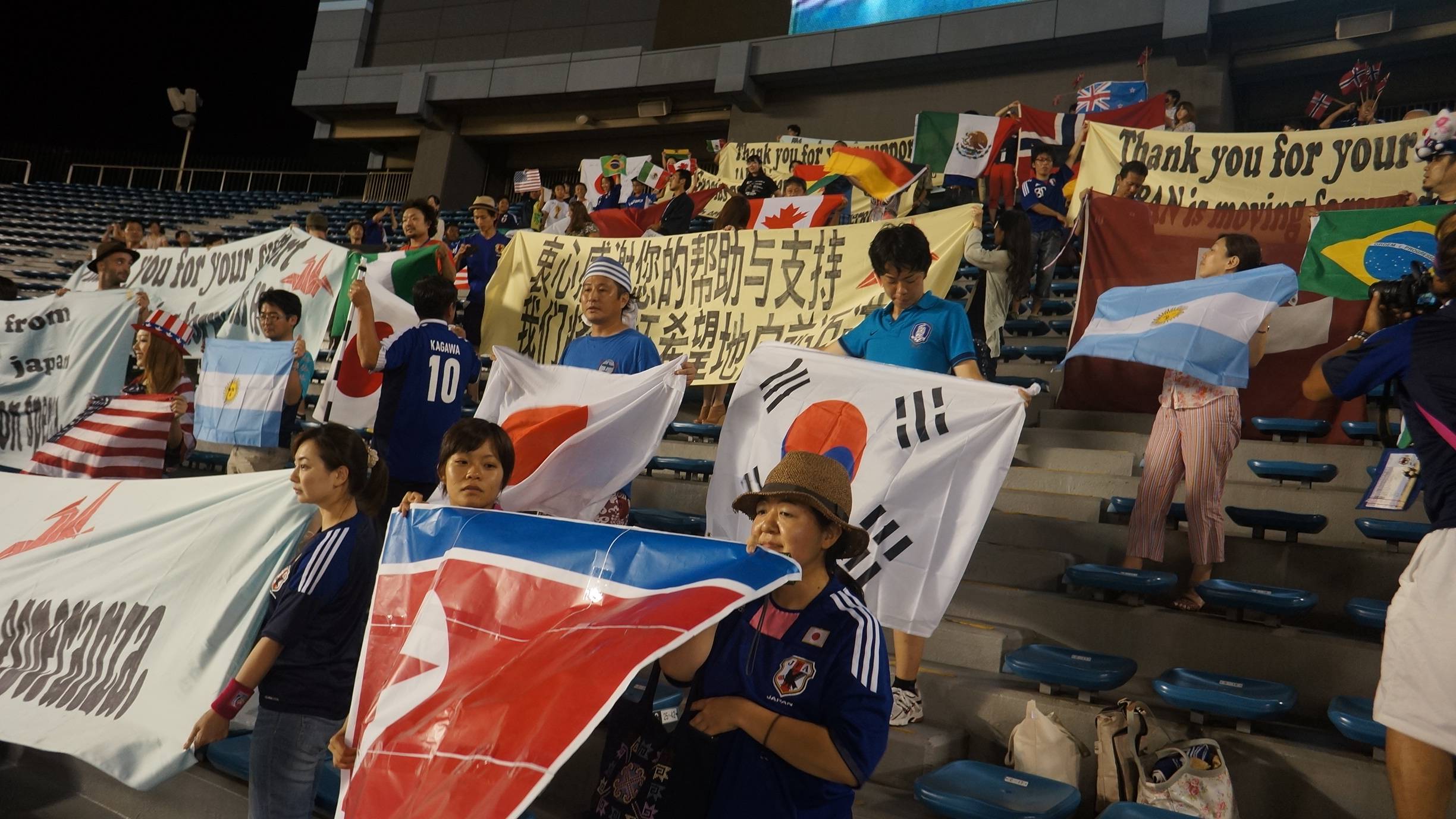 Japanese fans hold banners thanking foreign counties for their support after the March 11 disaster after the final of the U-20 Women's World Cup on Sept. 8, 2012, at Tokyo's National Stadium. | Courtesy of Hirokazu Tsunoda
